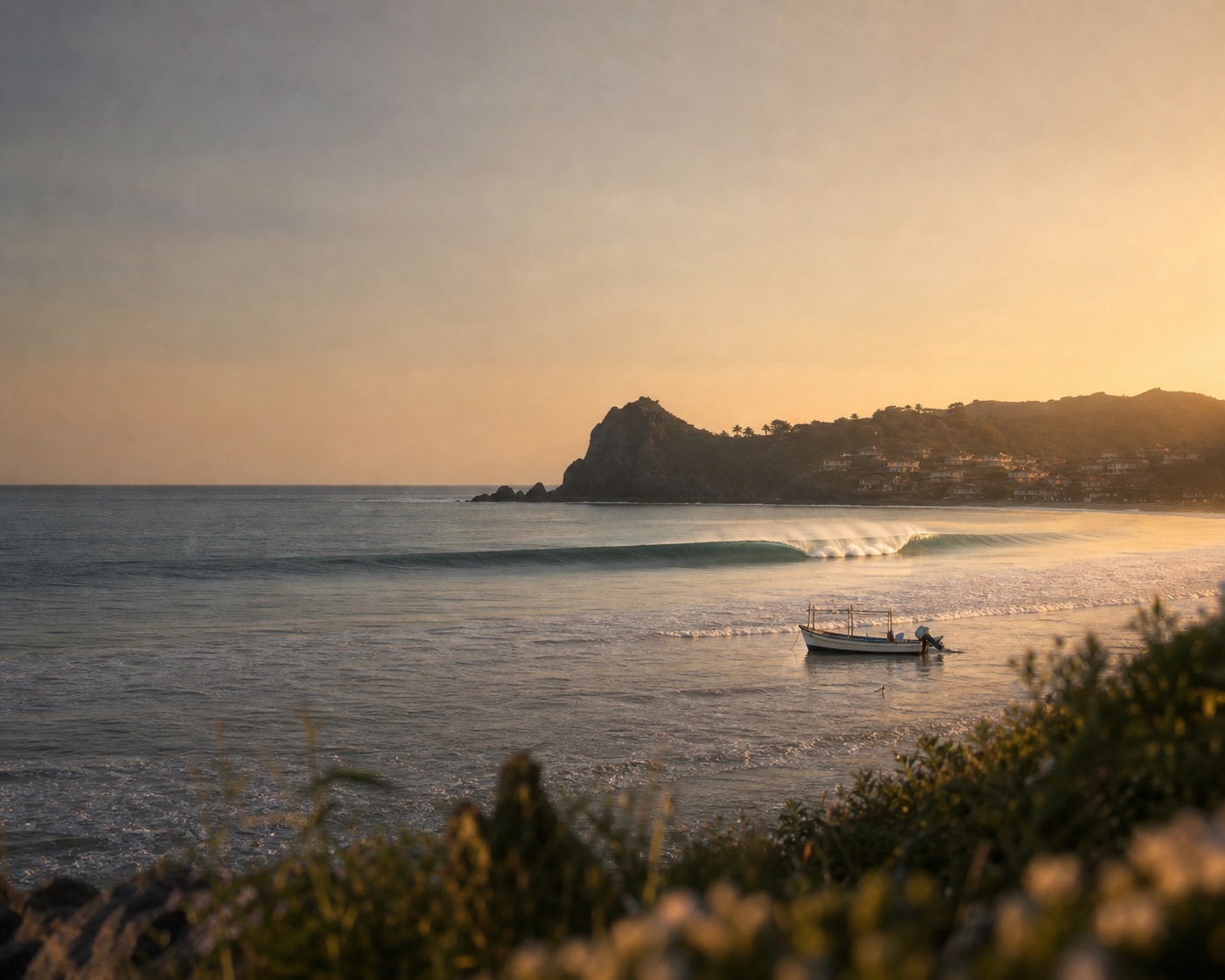 A long wave and fishing boat beneath Santa Catalina's volcanic point
