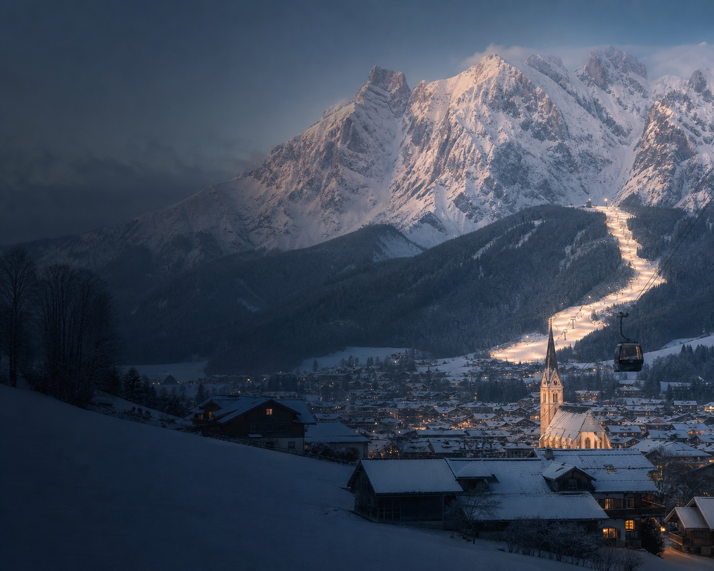 Schladming's church and Planai gondola beneath the Dachstein massif