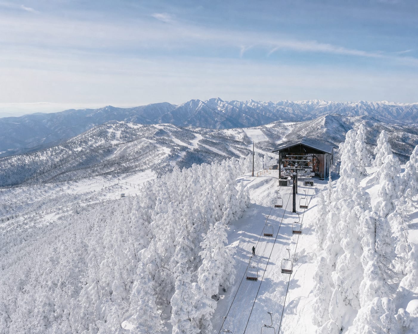 Shiga Kogen chairlift threading through Yokoteyama's snow-covered trees