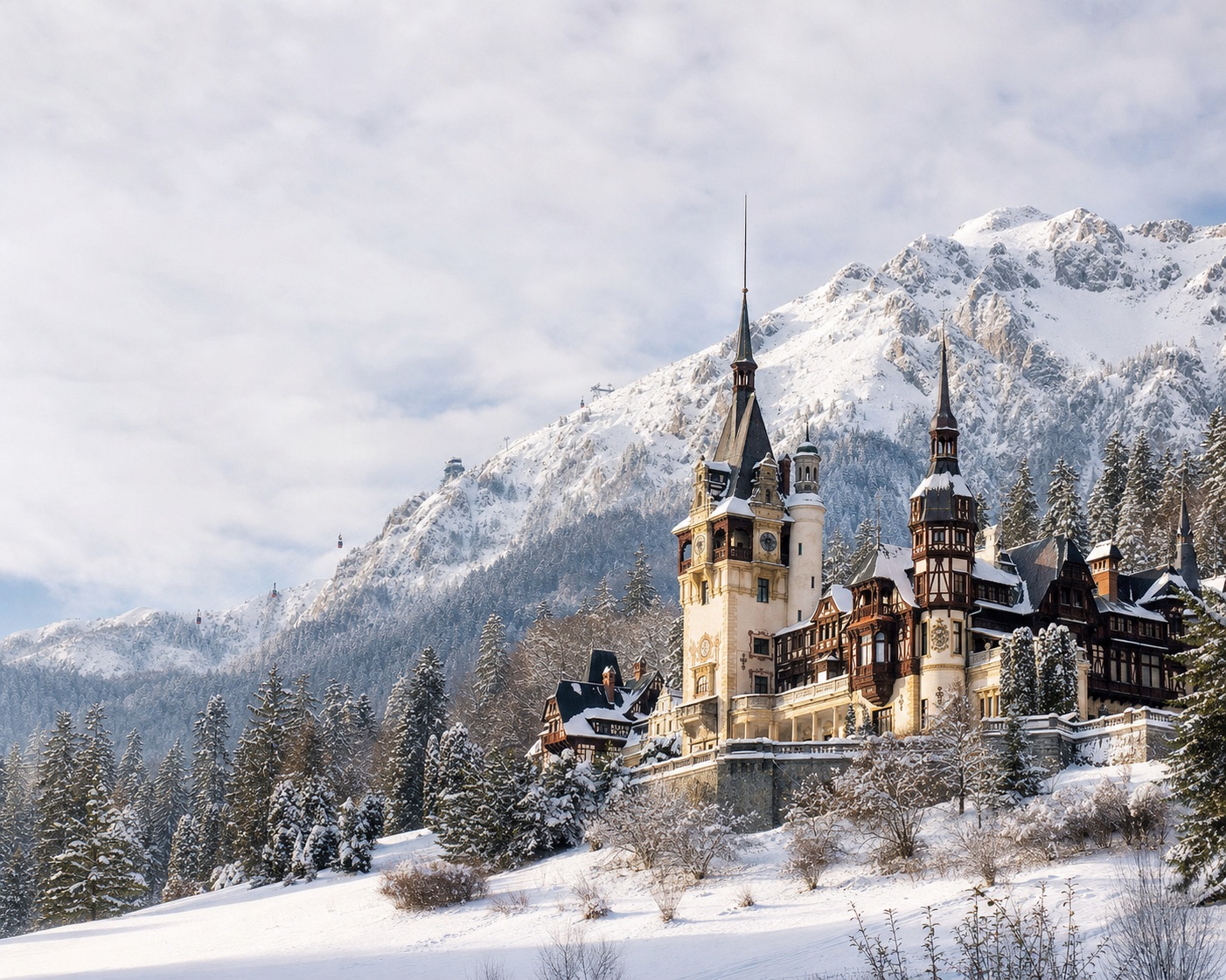 Peleș Castle beneath Sinaia's snowy Bucegi Mountains