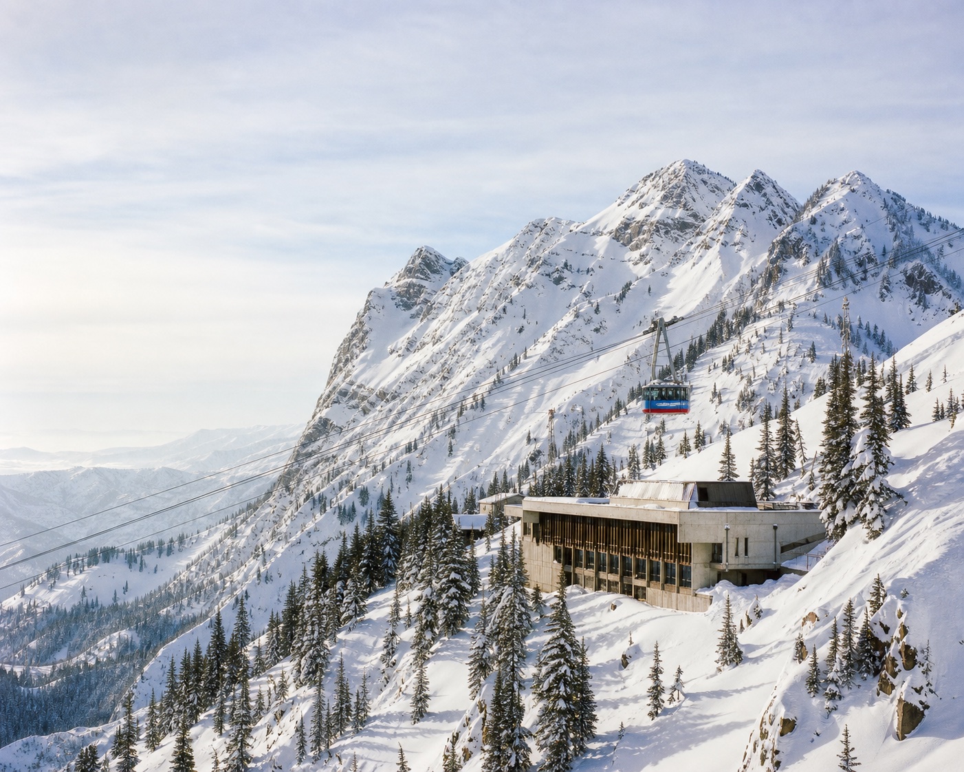 Snowbird's aerial tram passing the Cliff Lodge beneath Hidden Peak