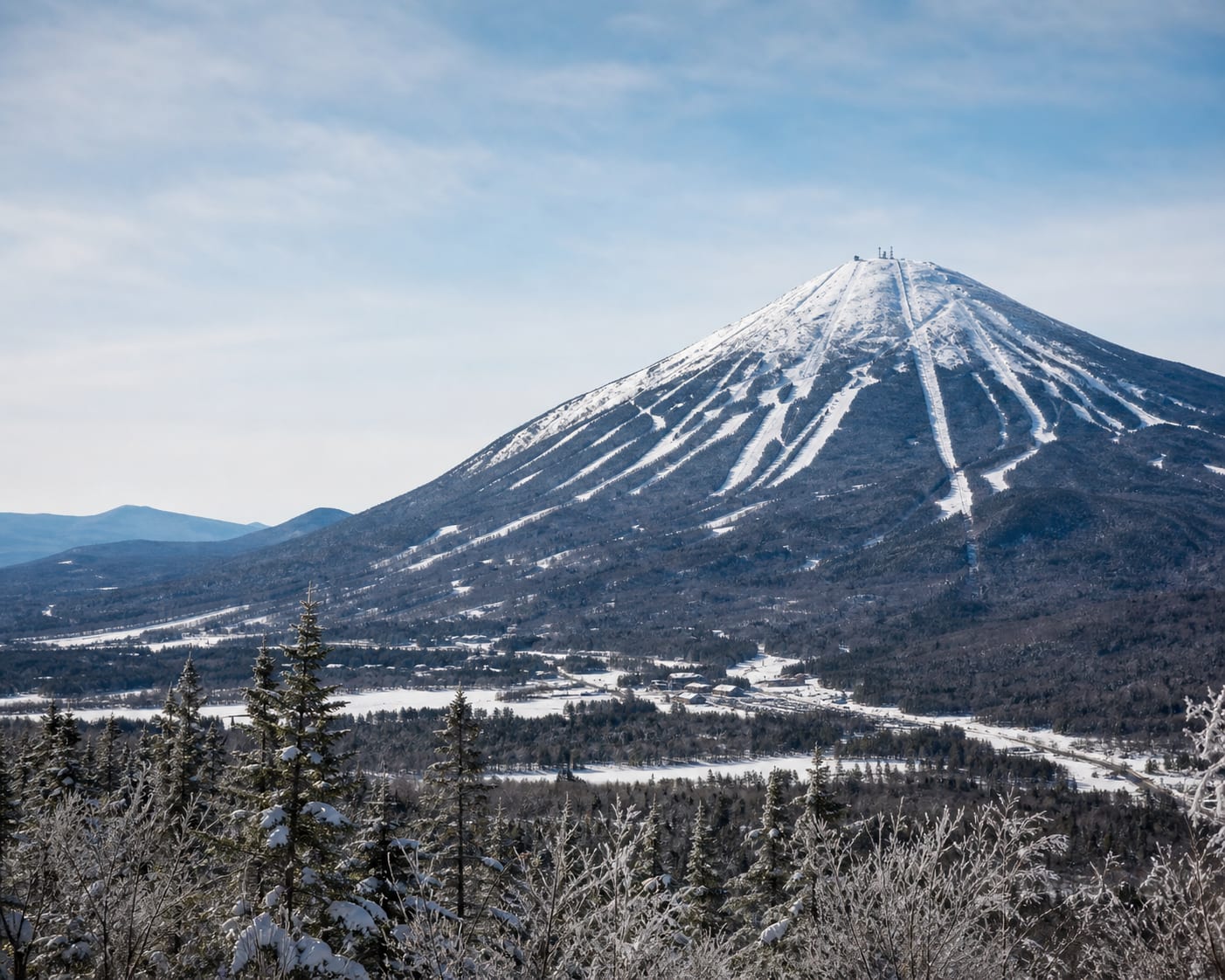 Sugarloaf's distinctive isolated peak and ski trails above Carrabassett Valley