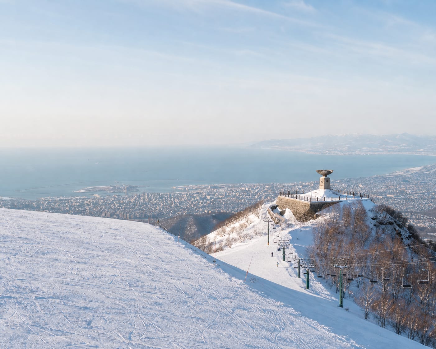 Sapporo Teine's Olympic flame cauldron above the city and Ishikari Bay