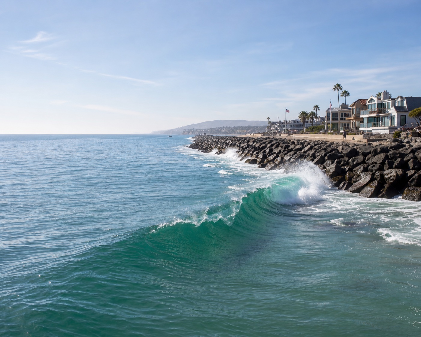 The Wedge shorebreak converging beside Newport Harbor's long rock jetty