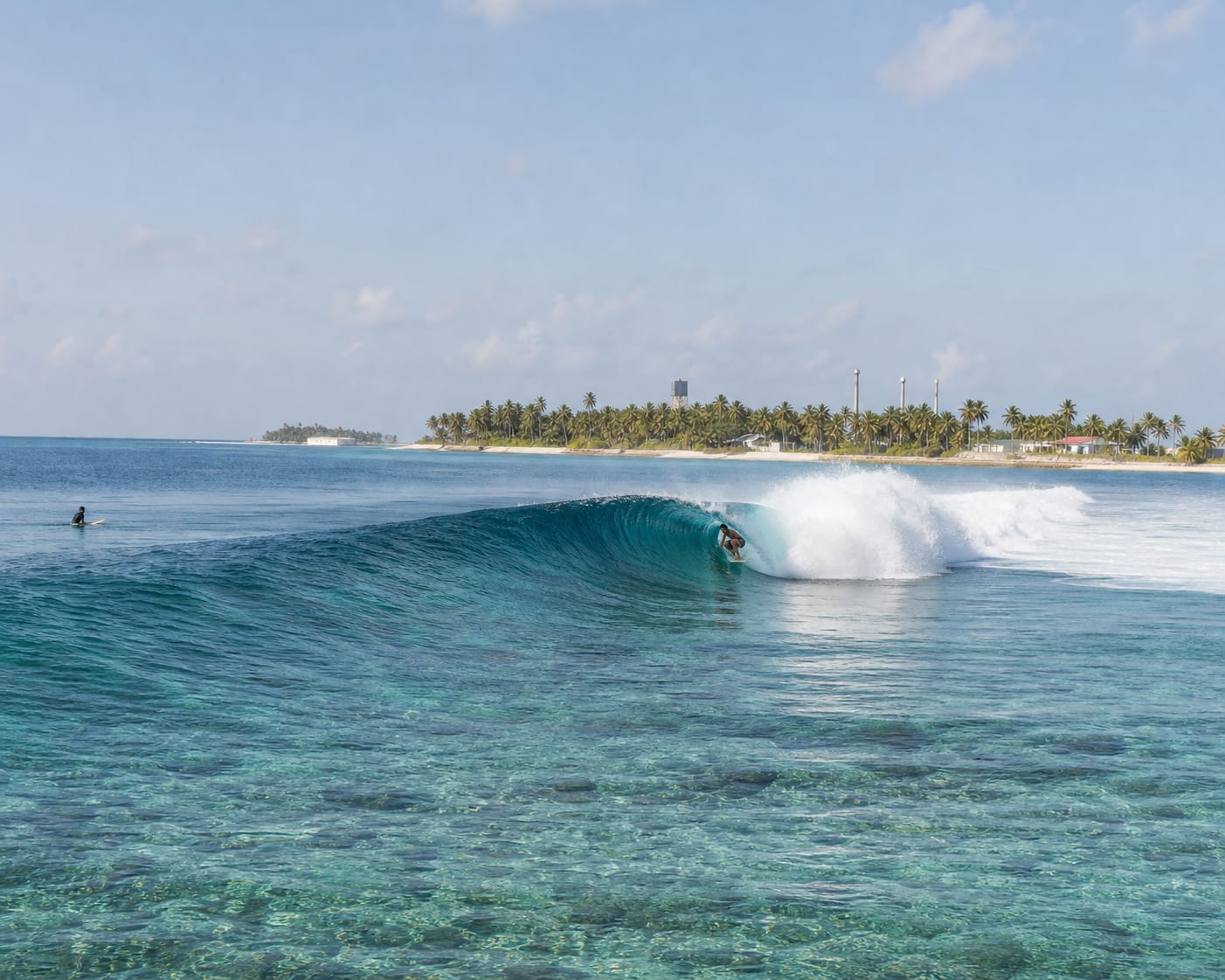 Cokes reef surf barrelling beside the palm-covered island of Thulusdhoo