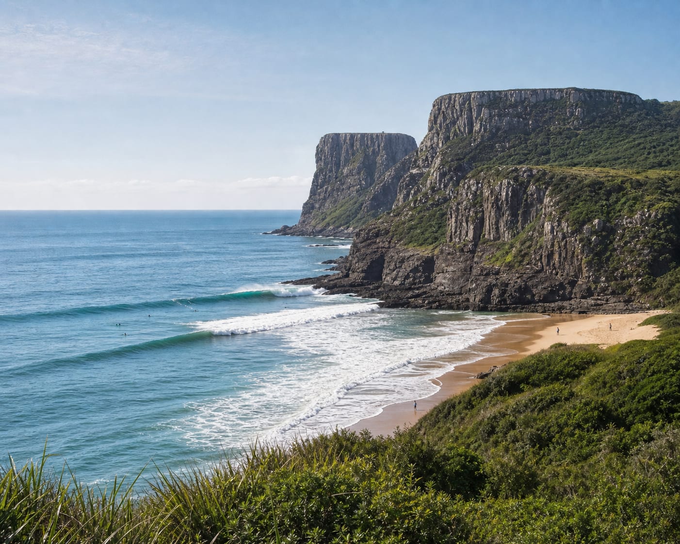 Praia da Guarita surf beneath Torres' monumental basalt cliffs