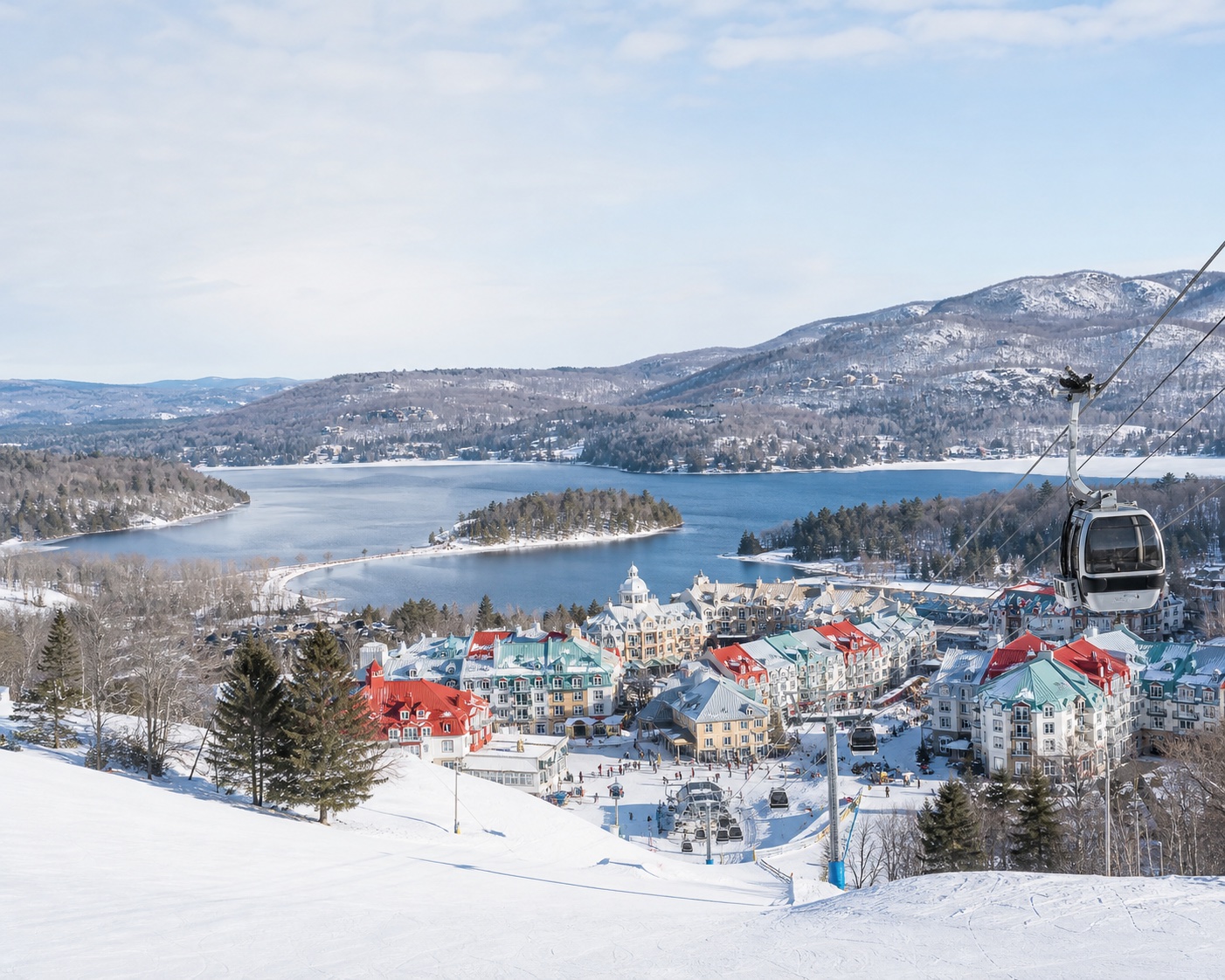 Tremblant gondola above its colourful village and frozen Laurentian lake