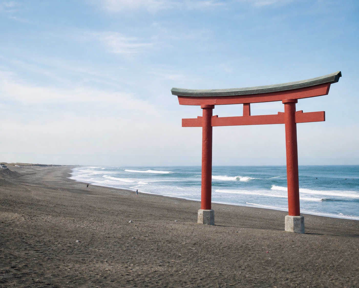Tsurigasaki surf breaking beside its ceremonial beach torii