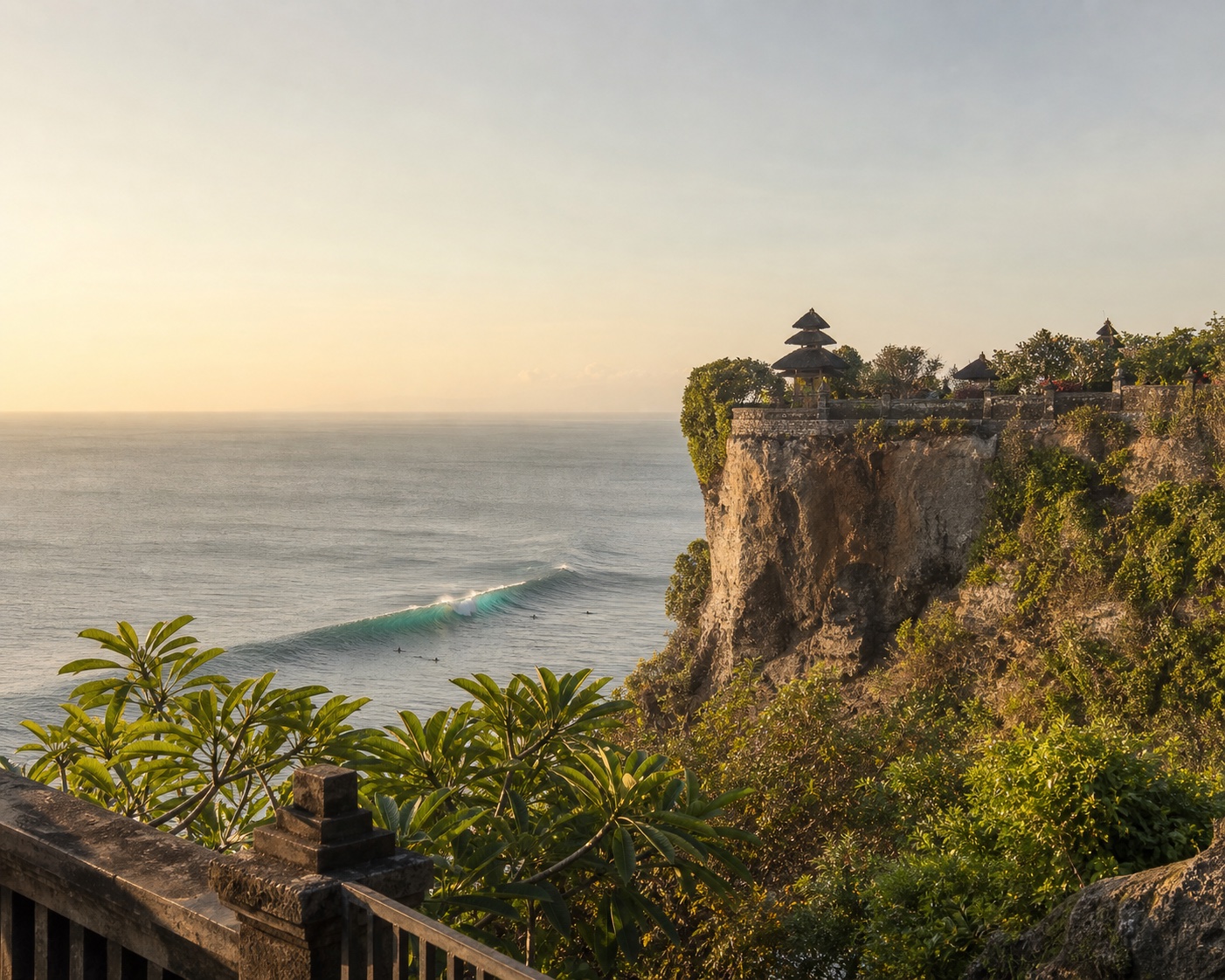 Uluwatu Temple above a peeling wave and Bali's limestone cliffs