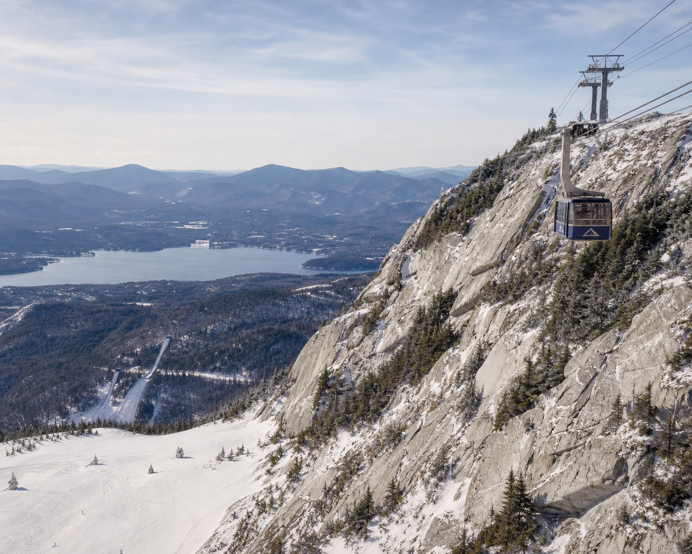 Whiteface gondola crossing pale rock above Lake Placid and the Adirondacks